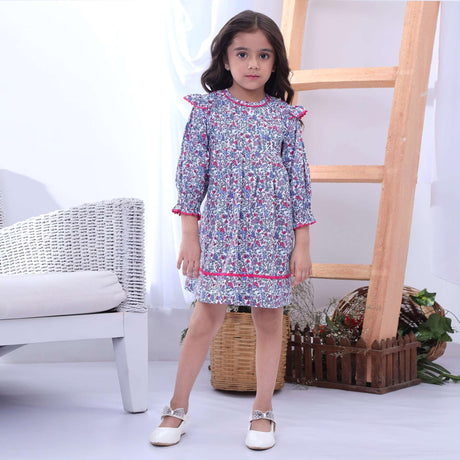 Girl wearing blue floral long sleeve dress with pink ric rac rims and pleating