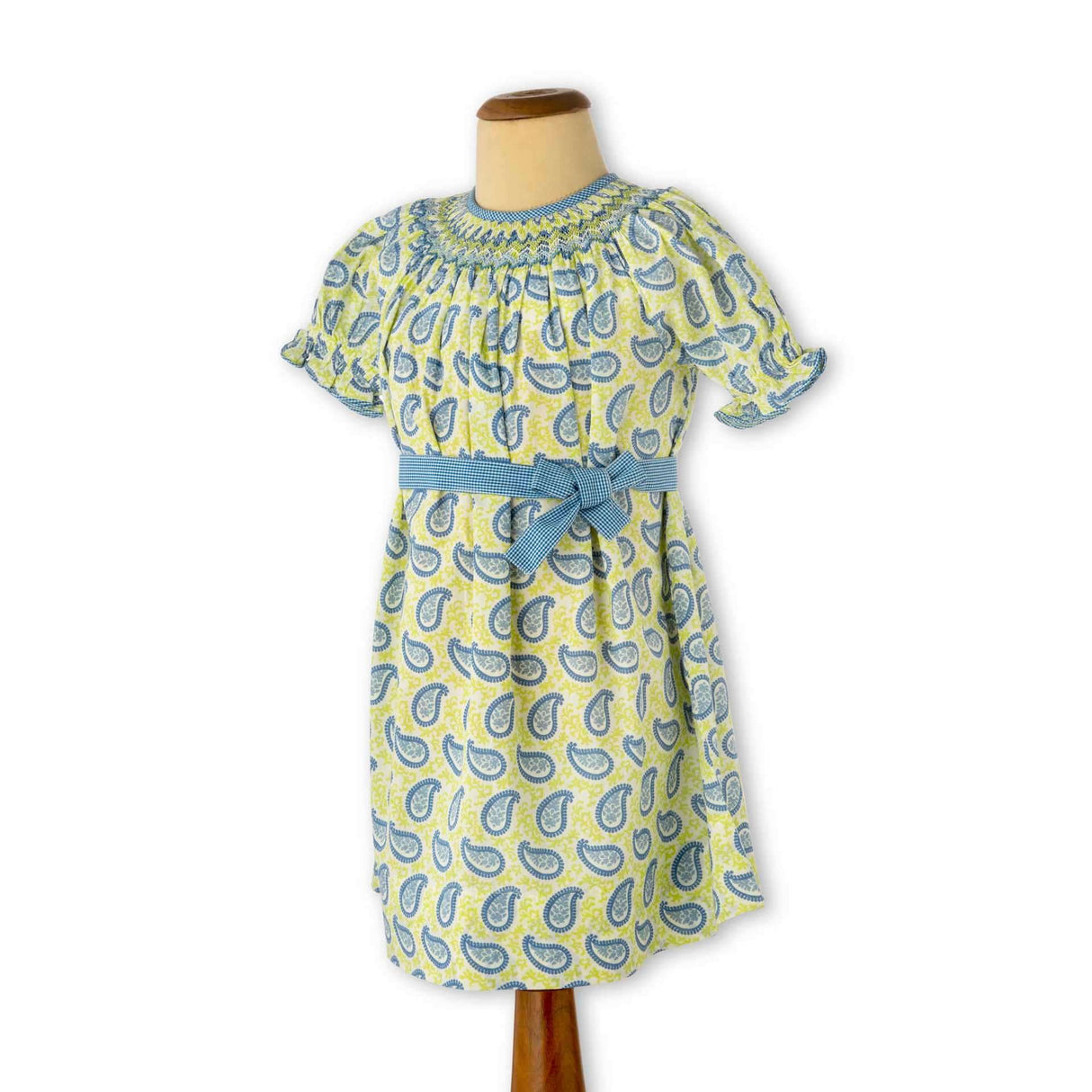 Smocked girls dress on mannequin in paisley orint