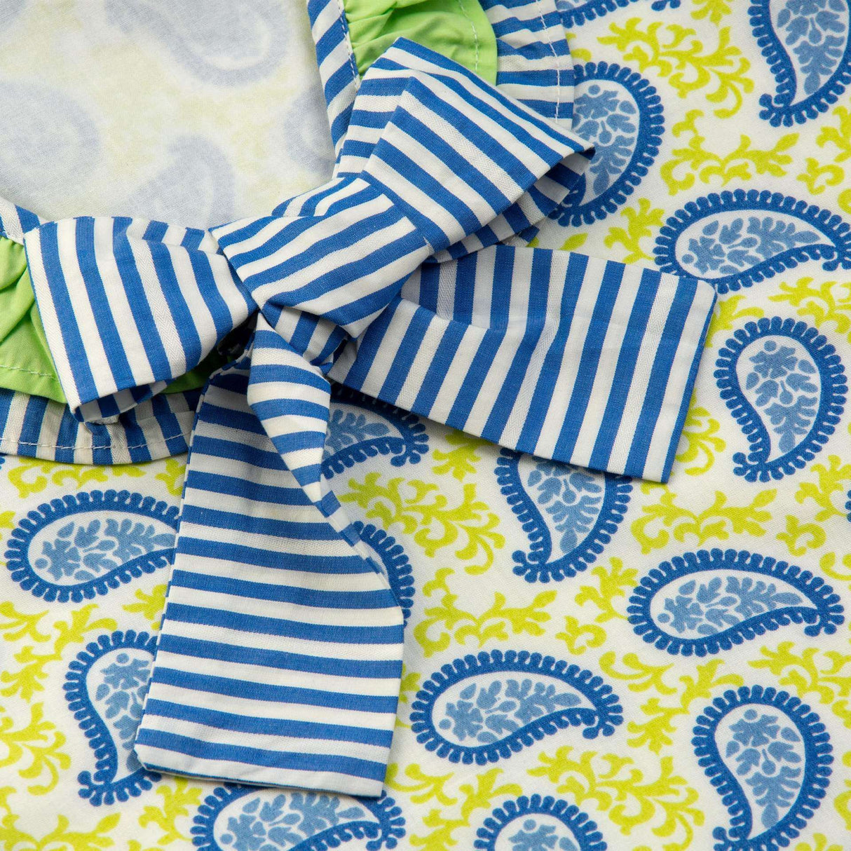 Blue stripe bow atop a paisley print dress