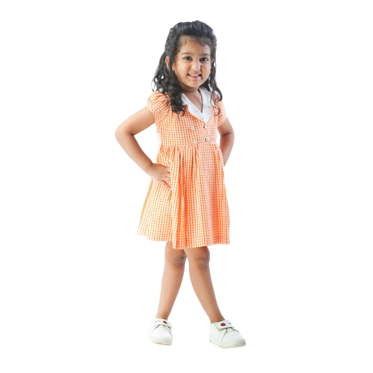 A young girl in orange gingham dress with a hand embroidered faux-collar