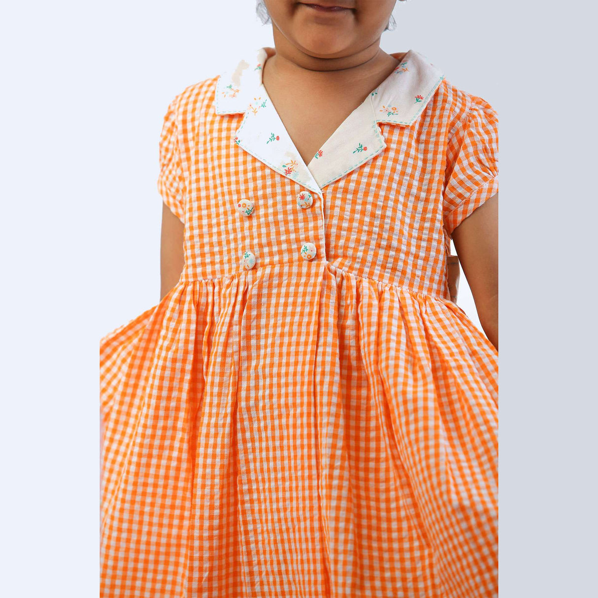 Double placket lapel collar girls dress in orange gingham with floral collar