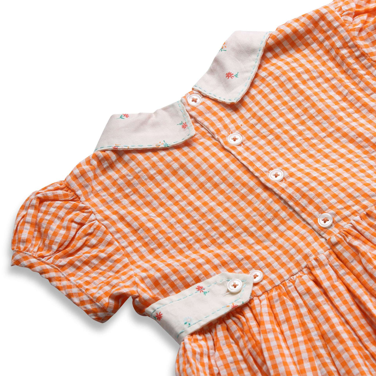 Close up of back side of orange gingham cotton lapel collar dress with buttoned backties
