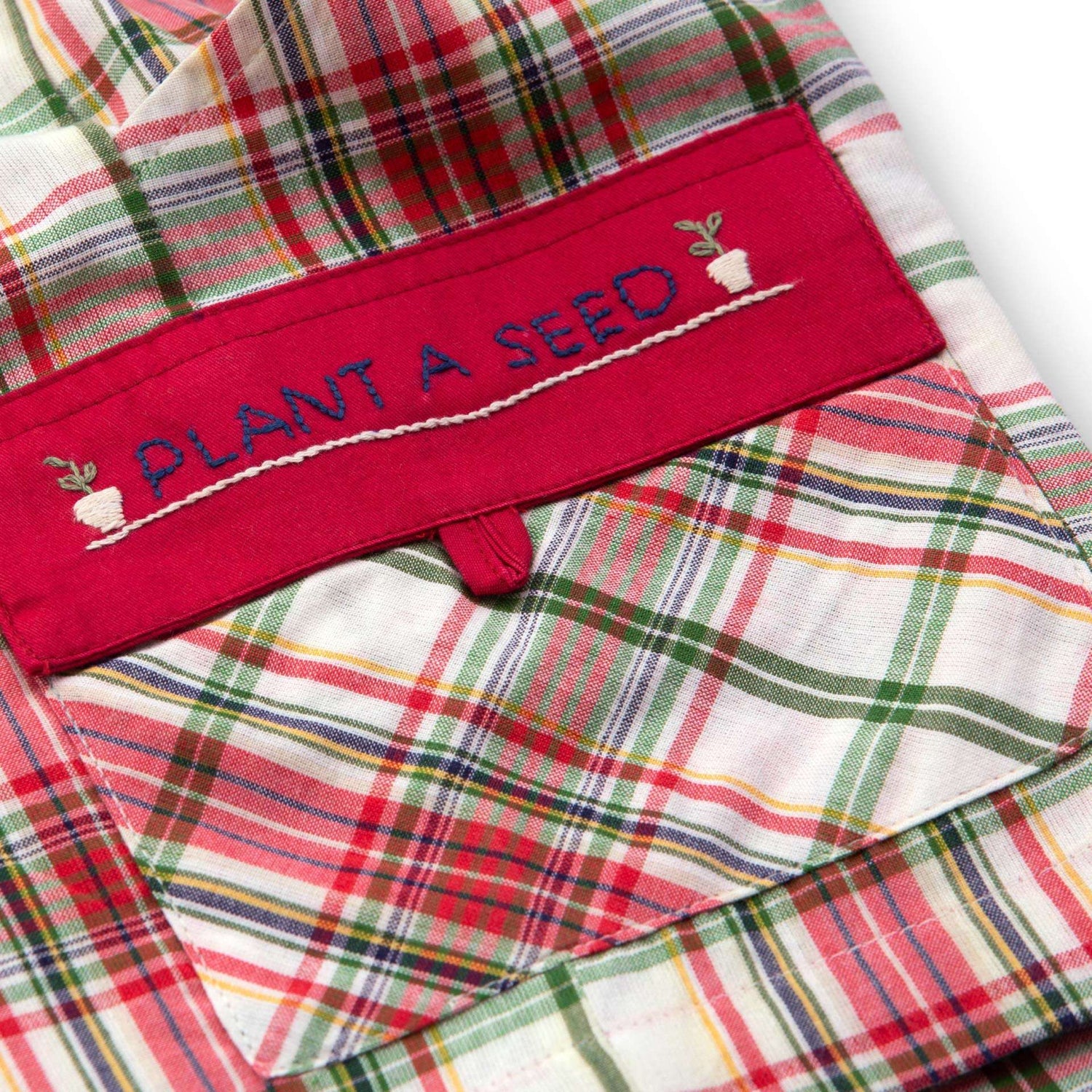 Inspirational message embroidered on pocket of boys red and green plaid shorts
