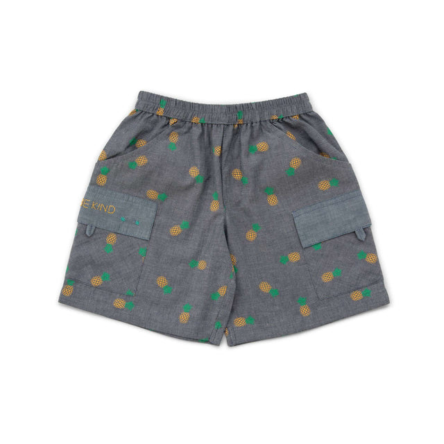 Flatlay of grey shorts with pineapple print and pockets with hand embroidered message