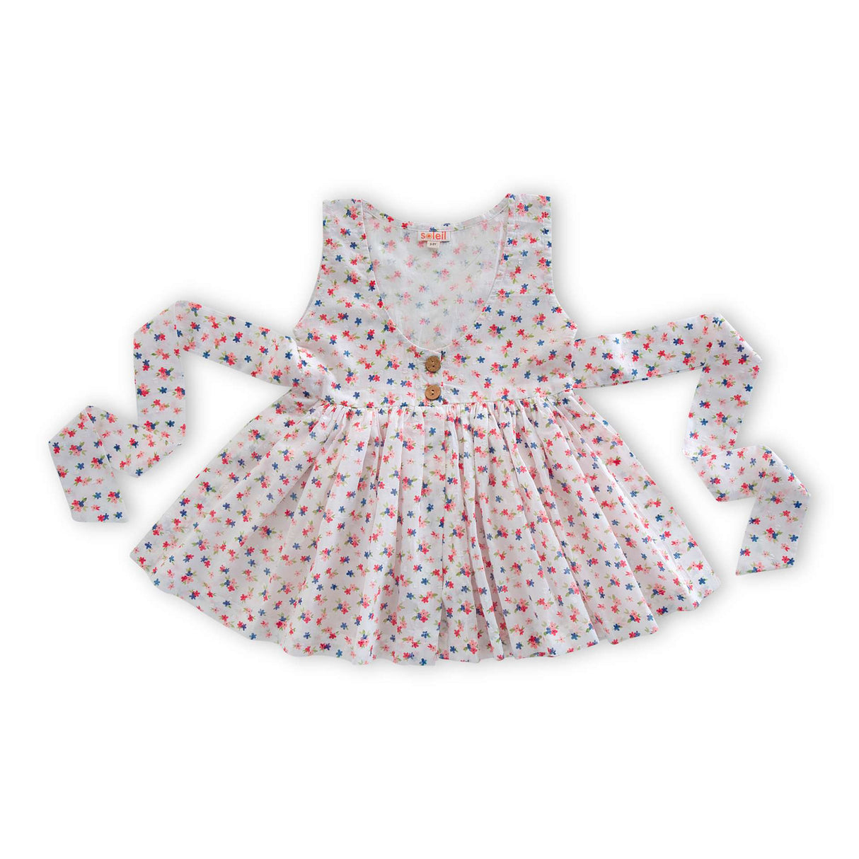 Flatlay of the floral printed cotton overdress with back tie ups and wooden button details