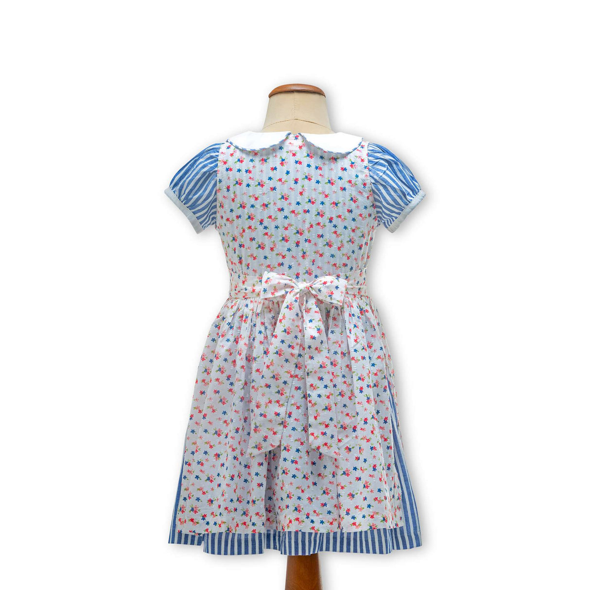 Rear mannequin shot of blue striped cotton dress with a hand embroidered collar and floral overdress