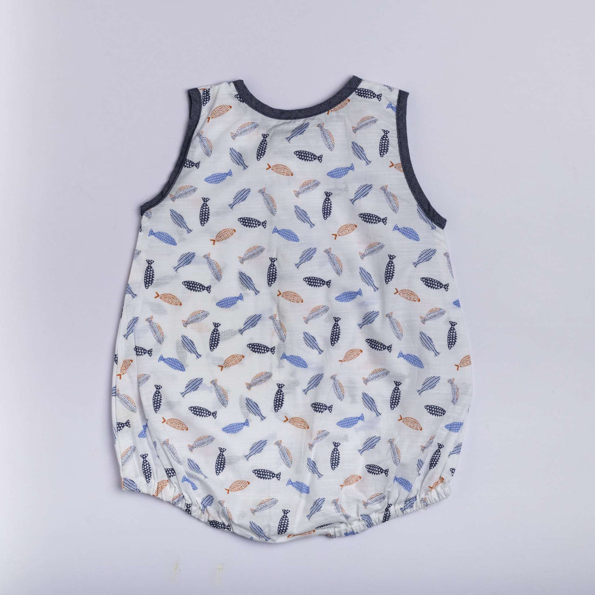 Infant romper in a fish print in shades of blue and orange