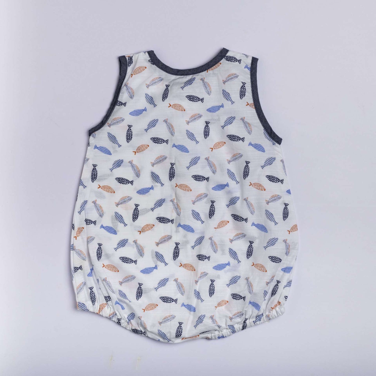 Infant romper in a fish print in shades of blue and orange