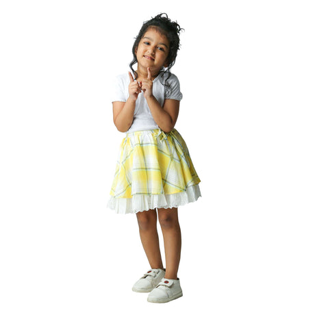 Girl wears an umbrella cut skirt in yellow plaid and lace hem