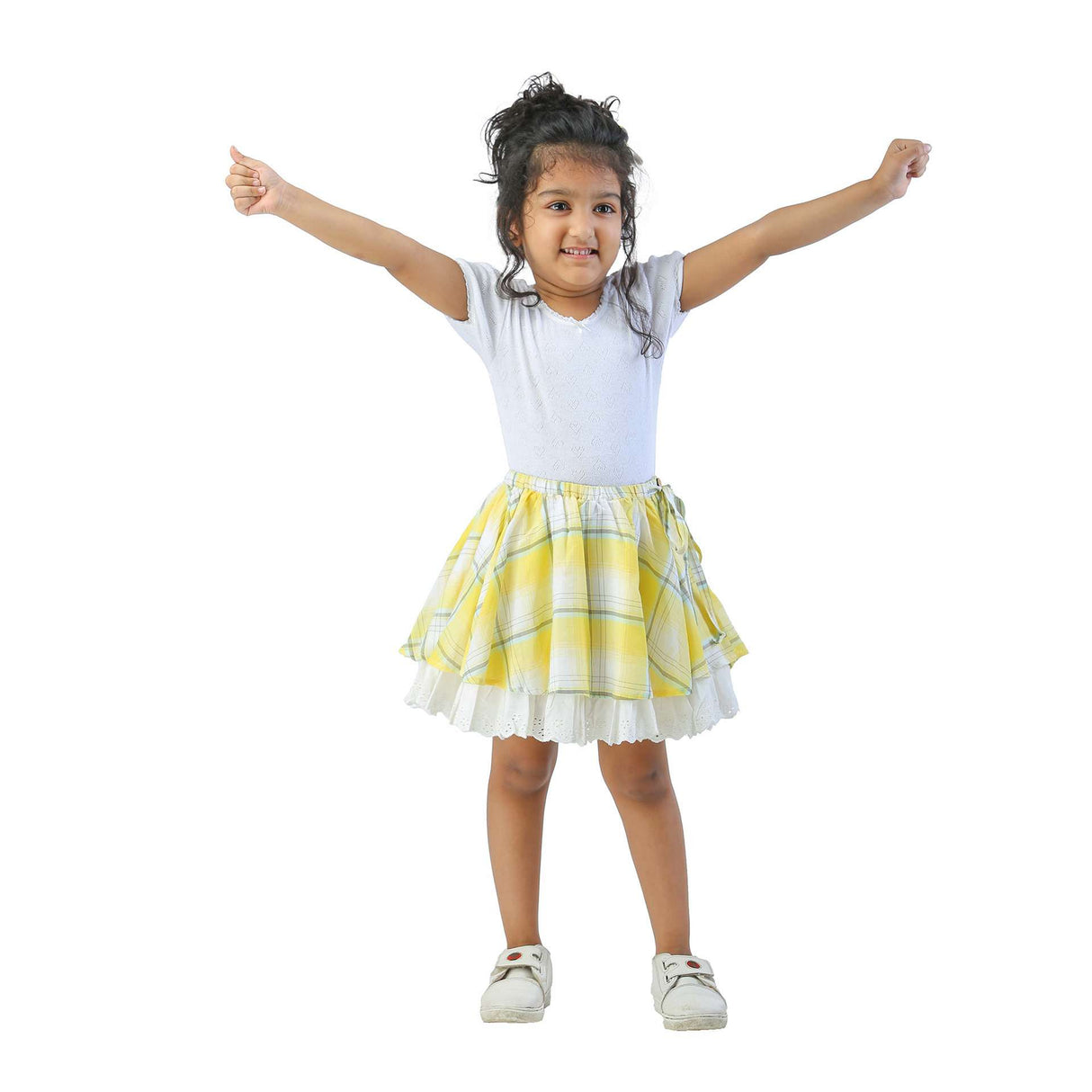 Yellow plaid umbrella skirt worn by a girl with a white tee