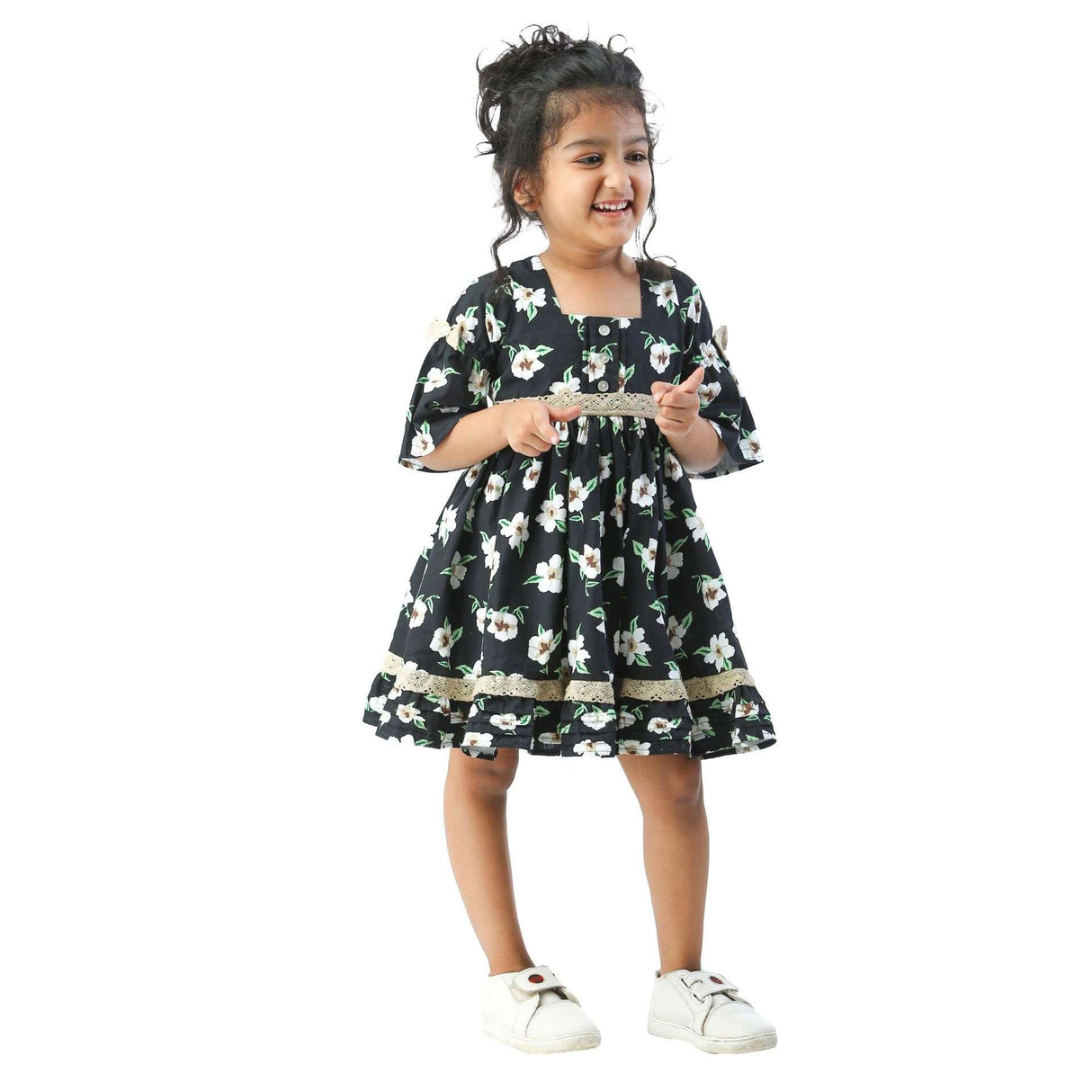 Girl weras a black and white floral print dress with elbow length sleeves and lace trims