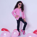 A little girl wearing fleece jacket lined in soft pink cotton, with pink gingham edging and a neckline ruffle
