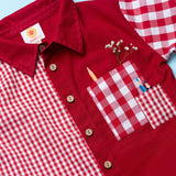 Flatlay of red checked shirt made from a patchwork of big and micro red gingham and solid red voile