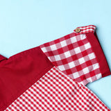 Close-up of red checks shirt made from a patchwork of big and micro red gingham and solid red voile