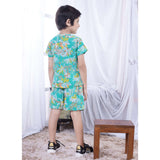 Rear image of a little boy in tropical print tee shirt and matching shorts set