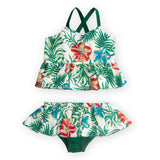 Flatlay of tropical print baby swimwear set with ruffle details on the bottom and strappy top