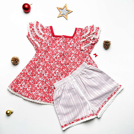 Flatlay of red floral tunic with layered ruffle sleeves paired with matching shorts