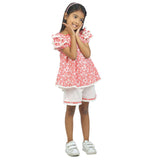 A little girl in red floral tunic with layered puff sleeves, contrast lace trims and hand embroidered details on neckline