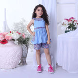 A girl in blue double gauze cotton tunic with floral ruffled neckline and tie-up belt paired with matching floral shorts