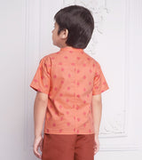 back view of boy wearing a orange geometric print shirt