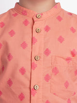 closeup of orange geometric print shirt with wooden buttons