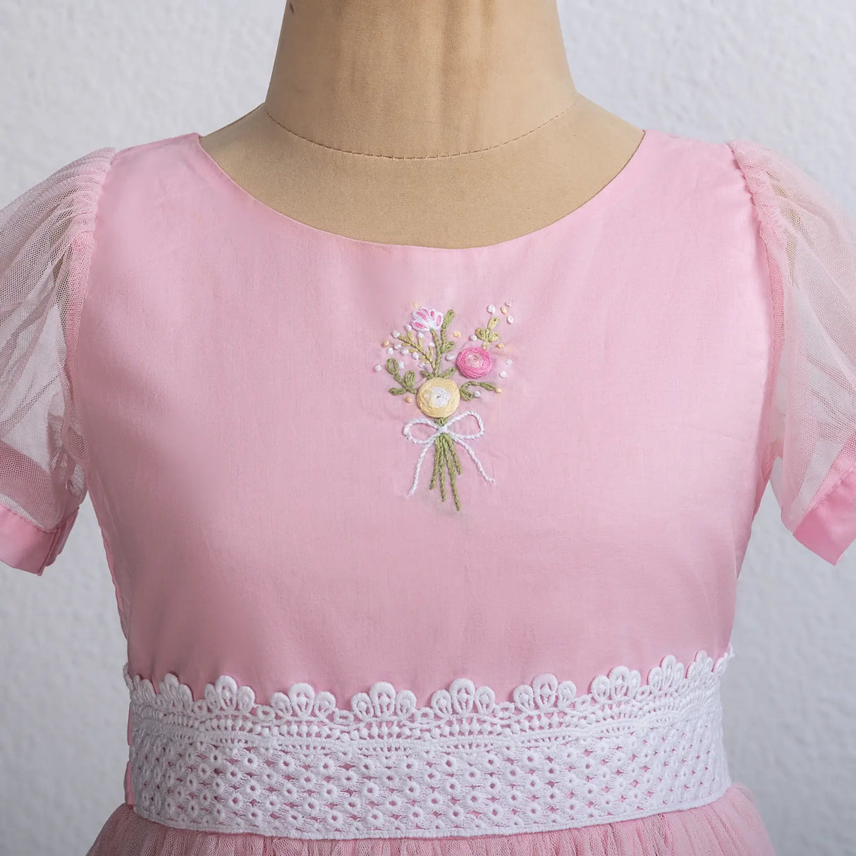 "Close-up of a bouquet hand-embroidered on a pink tulle dress."