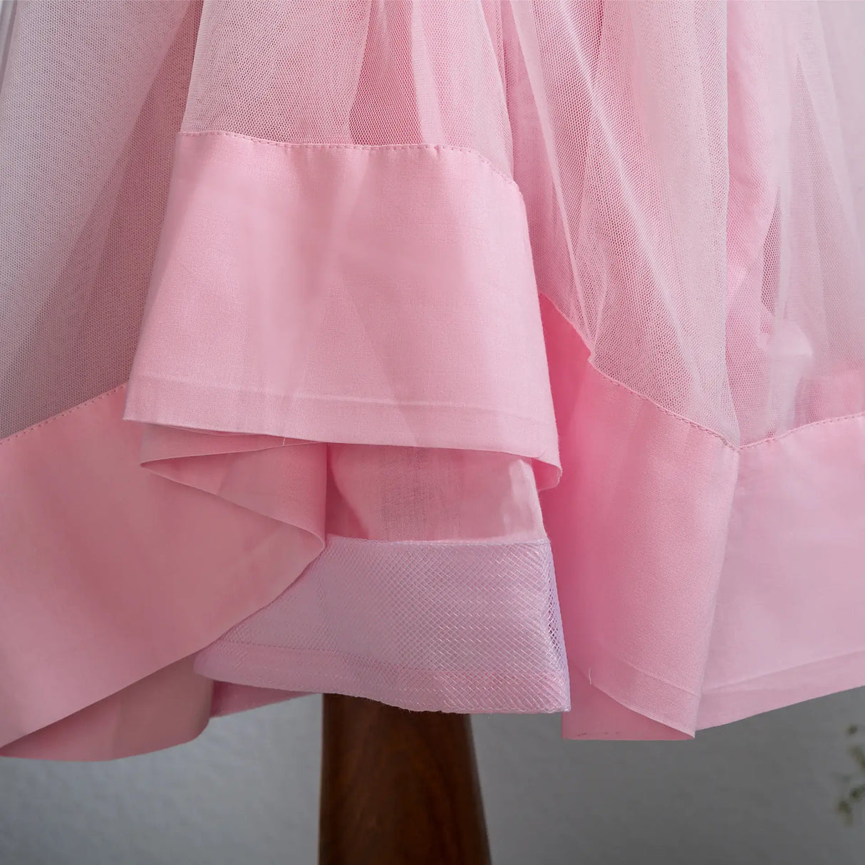 "Close-up of the can-can fabric attached to the pink tulle skirt of the dress."
