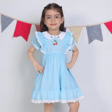 A little girl dressed in a blue embroidered cotton puffed sleeves dress.