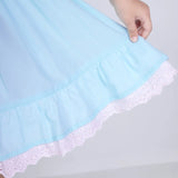 Close-up of the hem details on the blue cotton puffed sleeves dress.