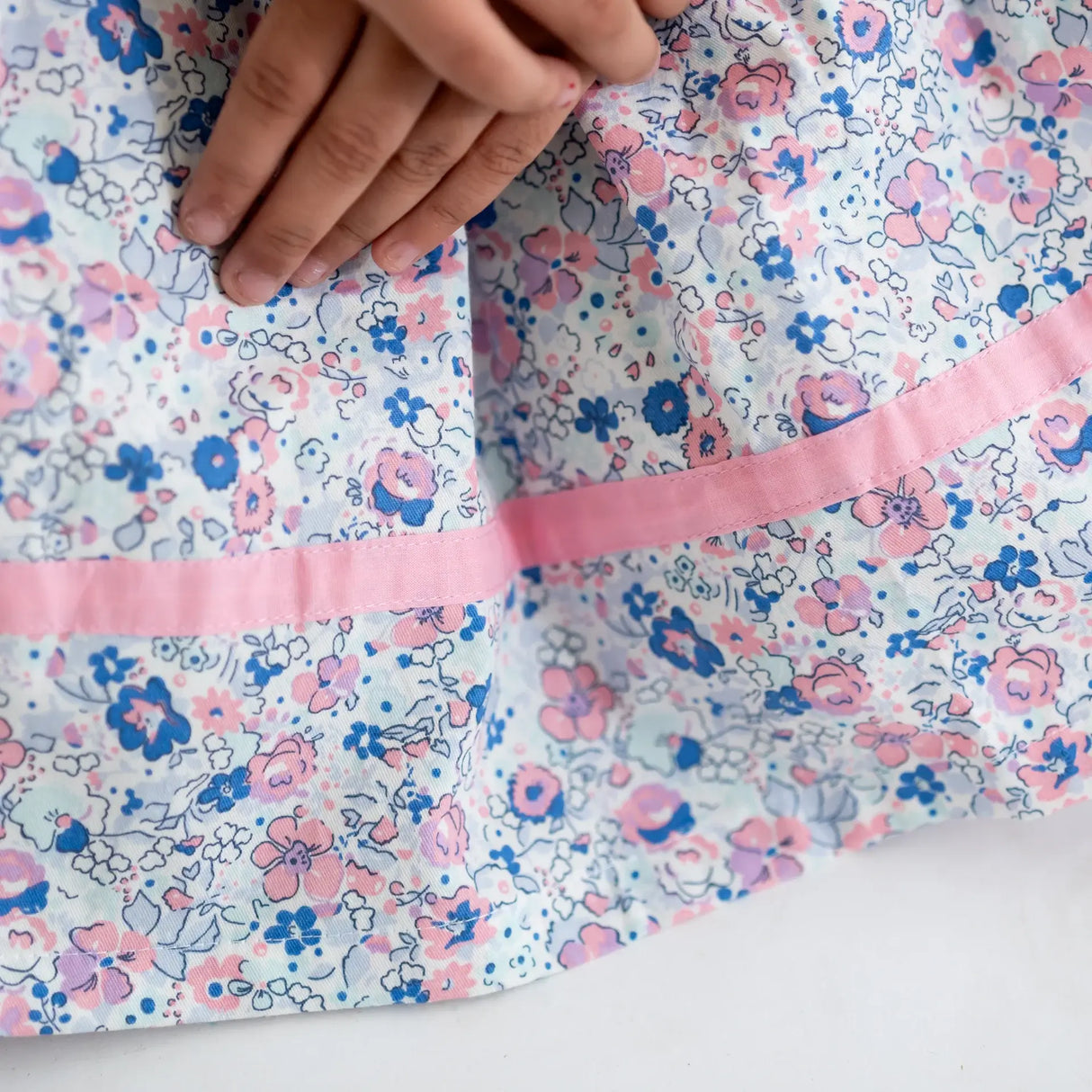 Close-up of a white floral printed strappy dress.