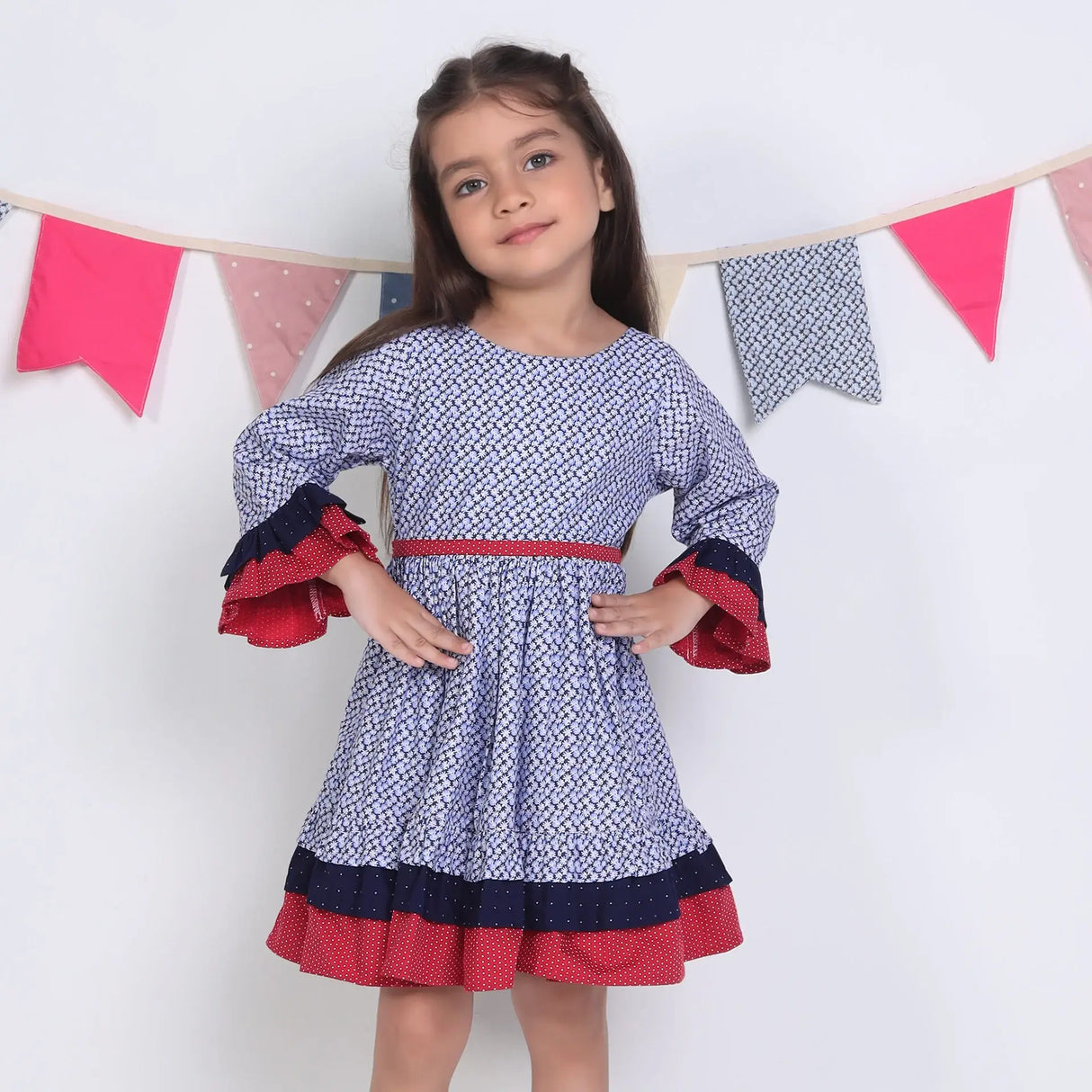 "A little girl posing in a navy floral printed cotton long ruffled sleeves dress."
