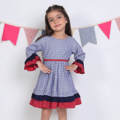 "A little girl posing in a navy floral printed cotton long ruffled sleeves dress."