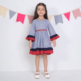 "A little girl dressed in a navy floral printed cotton long ruffled sleeves dress."
