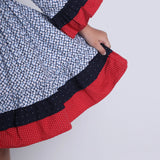 "Close-up of the layer details in a navy floral printed cotton long ruffled sleeves dress."