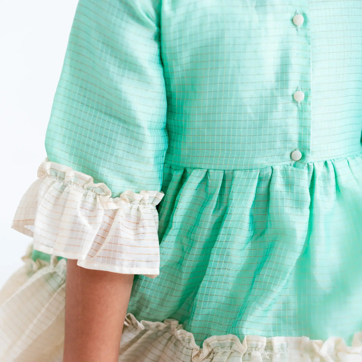 "Close-up details of the green zari checked cotton silk half sleeves dress."