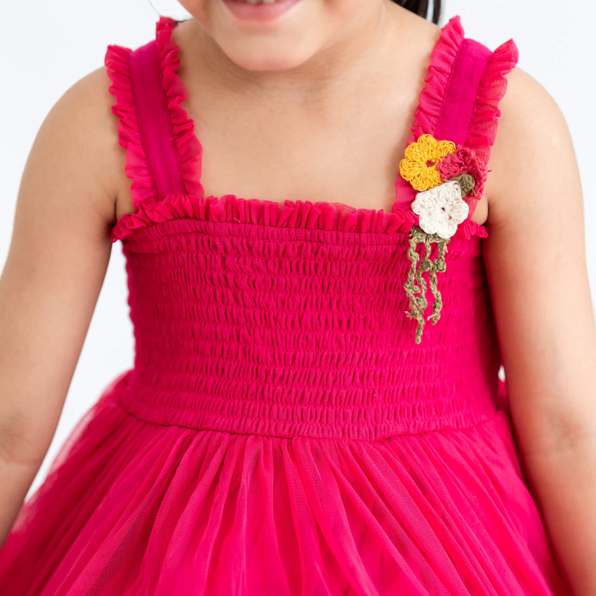 Close-up of a pink hand-embroidered crochet nylon tulle sleeveless dress.