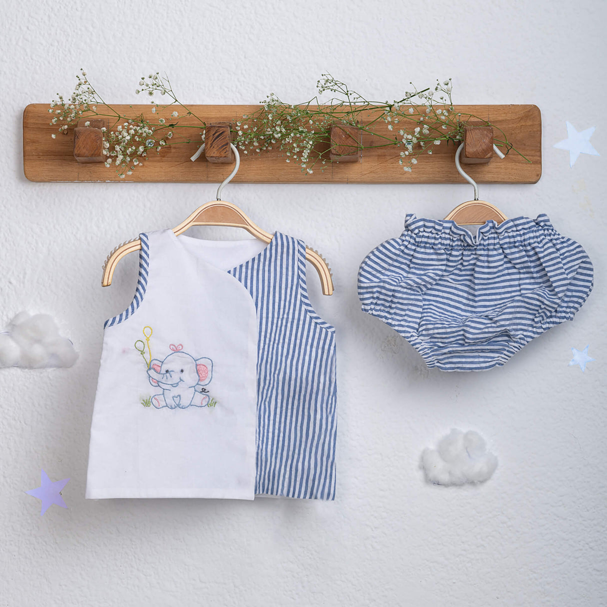 Hand-embroidered jabla with striped bloomer set from Soleilclo, hanging on hangers.