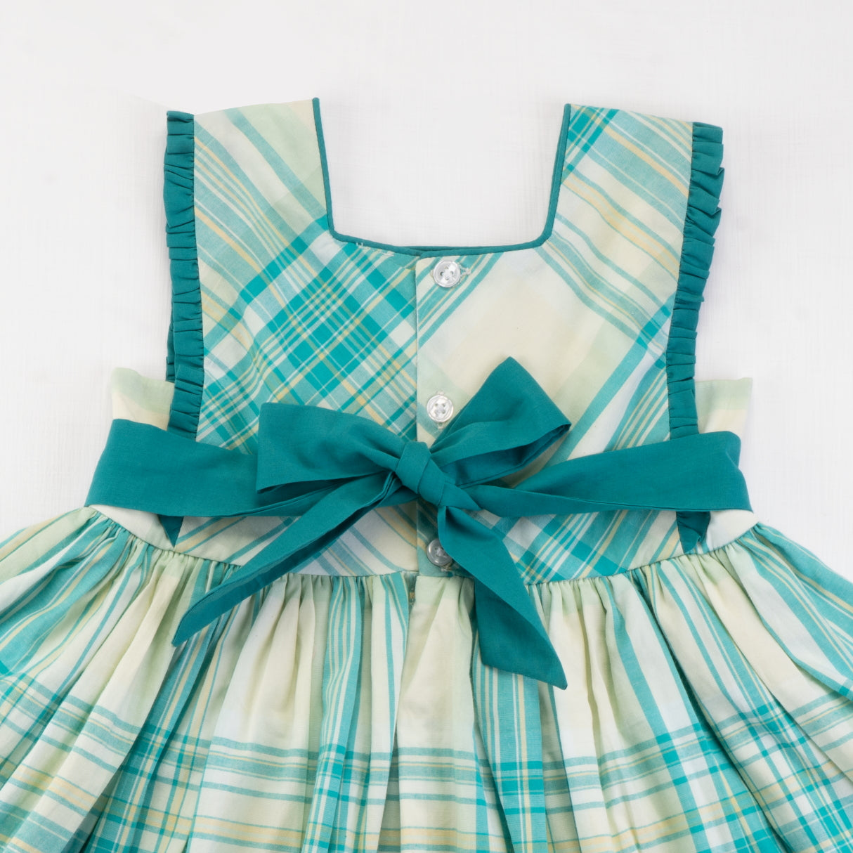 Close-up of the back ties of the green plaid cotton dress