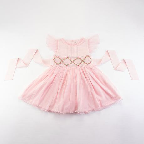 Front view of the pink smocked girls dress with flutter sleeves