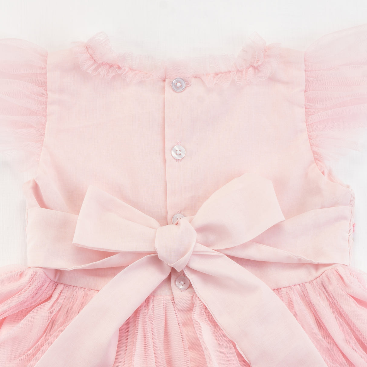 Close-up of the back button and tied bow