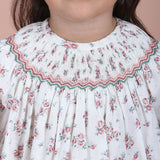 close-up of hand-smocked embroidered detail on the neckline