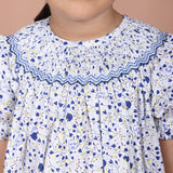 close-up of hand-smocked embroidered detail on the neckline