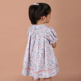 back view of the pastel floral bishop dress showing the back-button closure