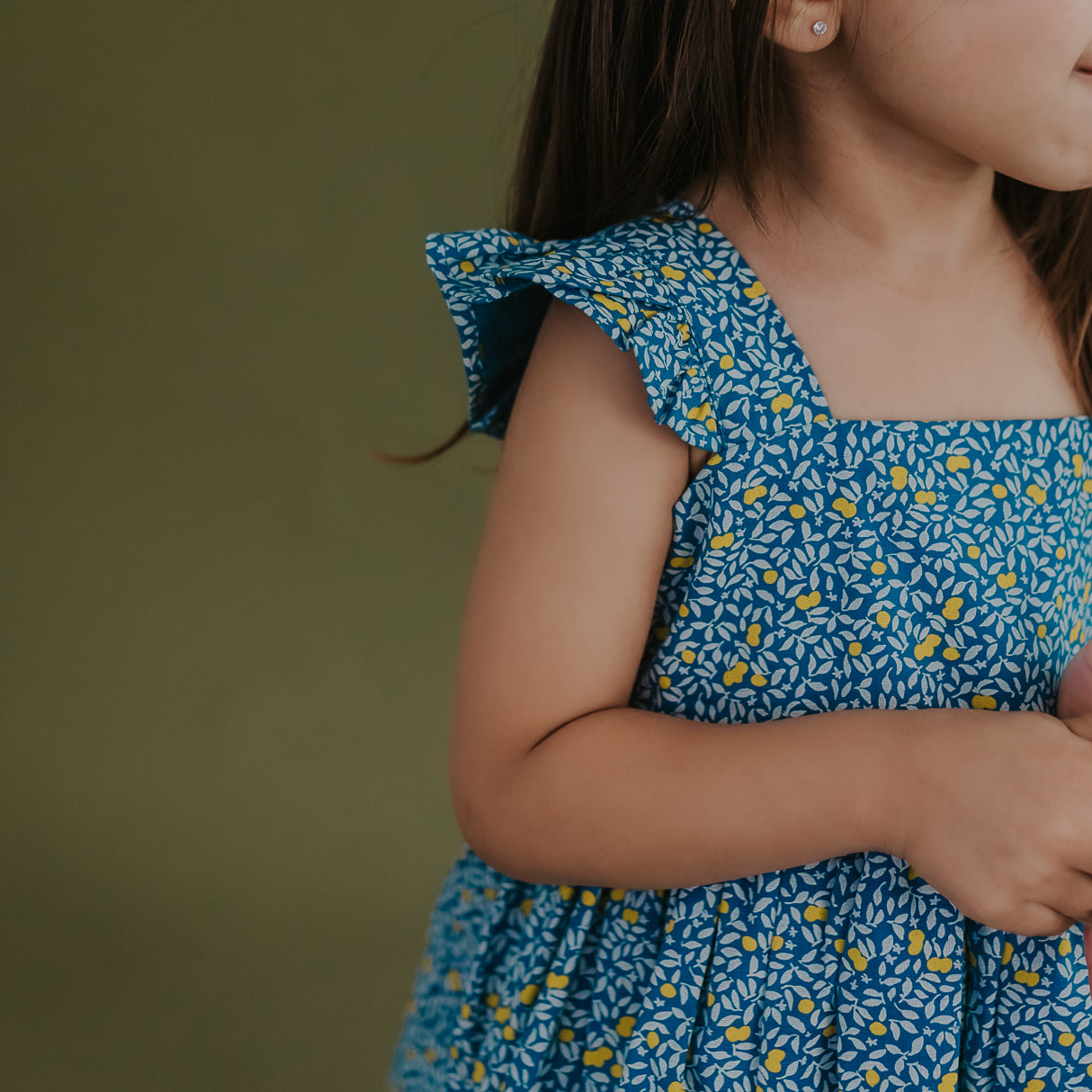 closeup of flutter sleeves of the blue citrus print dress