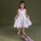 a little girl dressed in hakoba pink scallop hem dress
