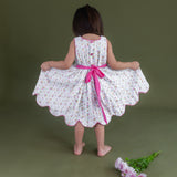 ackview of the little girl displaying the scallop hem of the hakoba pink scallop hem dress