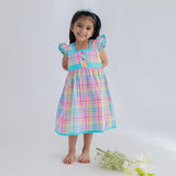 a little girl dressed in multicolour plaid ruffle sleeve dress