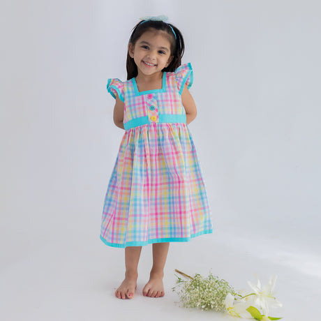 a little girl dressed in multicolour plaid ruffle sleeve dress