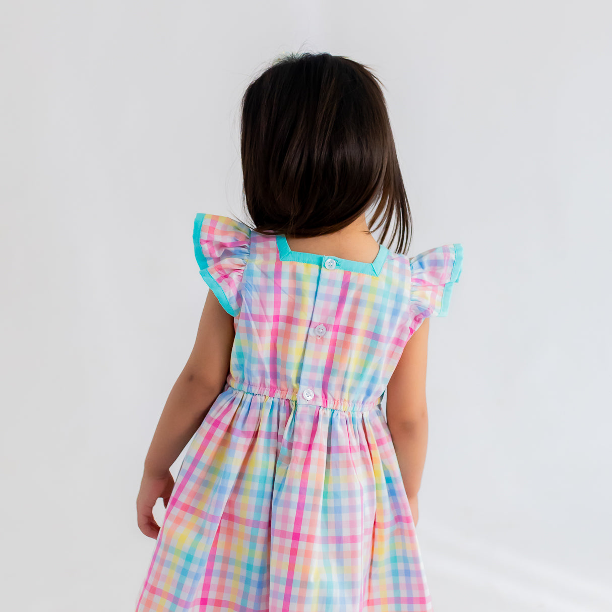 closeup of back buttons of the multicolour plaid dress