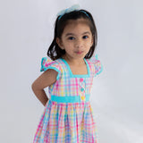closeup of ruffle sleeves and bodice of multicolour plaid dress